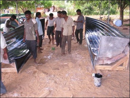 Workers inspecting the main molds after the fiber glass layers are allowed to dry for up to 12 hours.