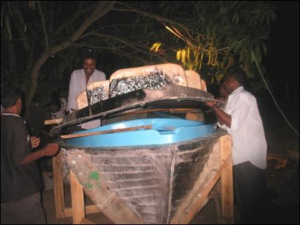 The two halves are tied together tightly and several layers of hardening compound including cement is used to fuse both halves. Mold is then separated leaving the sea-blue outer coating of the new boat left intact with the new body.