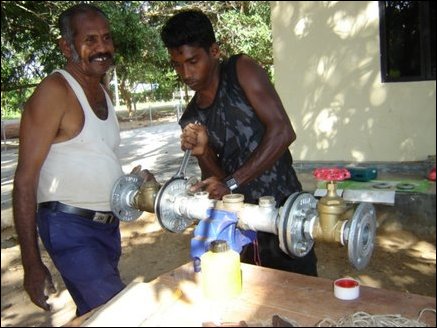 Workers installing necessary piping equipment for the deploying the network of pipes for drip irrigation.