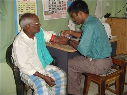 Locally trained lab technician prepares to get blood sample from a patient in a well equiped laboratory. 