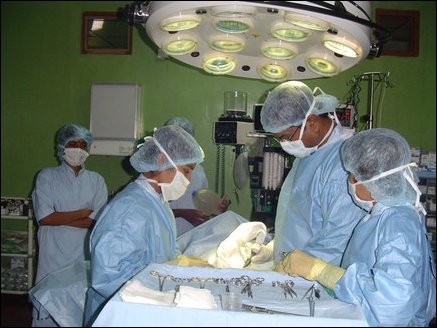Dr Sivapalan leading a surgical team. According to Dr Sivapalan the Hospital only charges patients who can afford. Most of the services performed by the Hospital are therefore done free of charge.