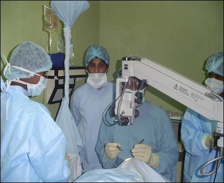 British eye surgeon, Dr Puvanachanthiran, helping staff with the intricacies of performing eye surgery.
