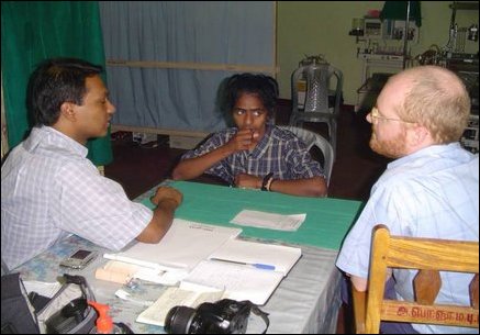 Plastic surgeon from UK, Dr Philip Grey, determining the surgery required to help a female patient.