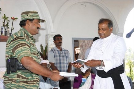 A book containing narratives by a young journalist Mr. Logeesan was released at the Church. Special Commander of the Sea Tigers, Col. Soosai is handing over the first copy of the book to Rev. James Pathinathar