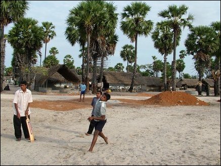 Children playing cricket with 